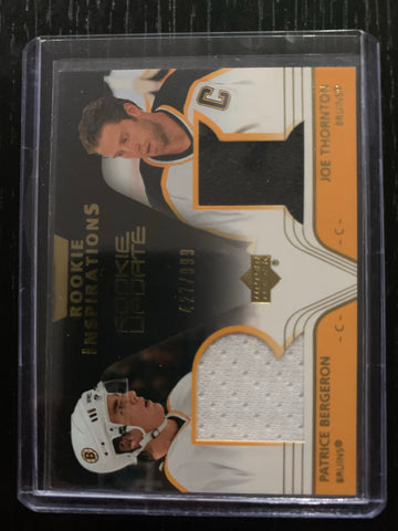 2003-04 UPPER DECK ROOKIE INSPIRATIONS #151 BOSTON BRUINS - PATRICE BERGERON / JOE THORNTON DUAL JERSEY CARD RAW